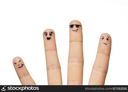 gesture, family, people and body parts concept - close up of two hands showing fingers with smiley faces
