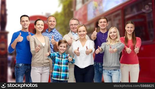 gesture, family, travel and tourism concept - group of smiling people showing thumbs up over london city street background
