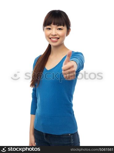 gesture, fashion, portrait and people concept - happy smiling young asian woman showing thumbs up over white . happy smiling young woman showing thumbs up