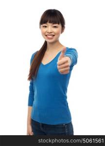 gesture, fashion, portrait and people concept - happy smiling young asian woman showing thumbs up over white . happy smiling young woman showing thumbs up