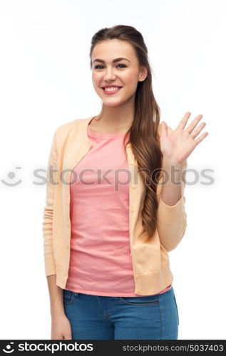 gesture, fashion, portrait and people concept - happy smiling young woman in cardigan waving hand over white. happy smiling young woman waving hand over white