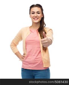 gesture, fashion, portrait and people concept - happy smiling young woman in cardigan showing thumbs up over white. happy smiling young woman showing thumbs up