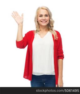 gesture, fashion, portrait and people concept - happy smiling young woman in red cardigan waving hand over white. happy smiling young woman waving hand over white