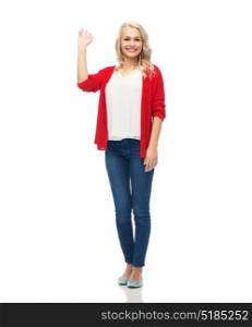 gesture, fashion, portrait and people concept - happy smiling young woman in red cardigan waving hand over white. happy smiling young woman waving hand over white