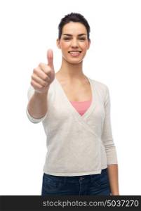 gesture, fashion, portrait and people concept - happy smiling young woman with braces showing thumbs up over white. happy smiling woman with braces showing thumbs up