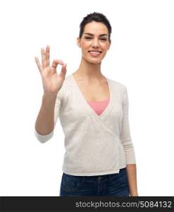 gesture, fashion, portrait and people concept - happy smiling young woman with braces showing ok hand sign over white. happy smiling woman with braces showing ok. happy smiling woman with braces showing ok