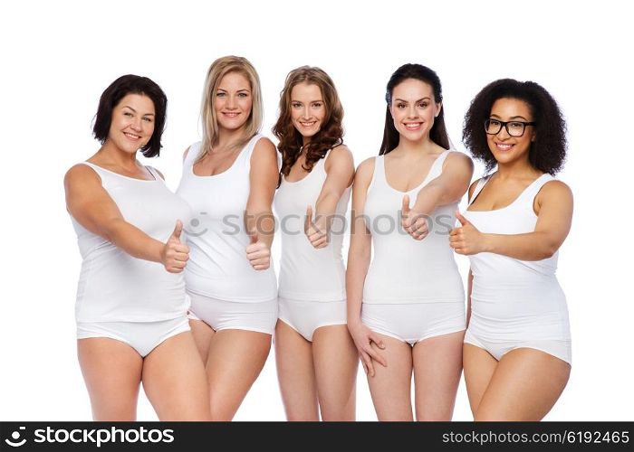 gesture, friendship, beauty, body positive and people concept - group of happy different women in white underwear showing thumbs up