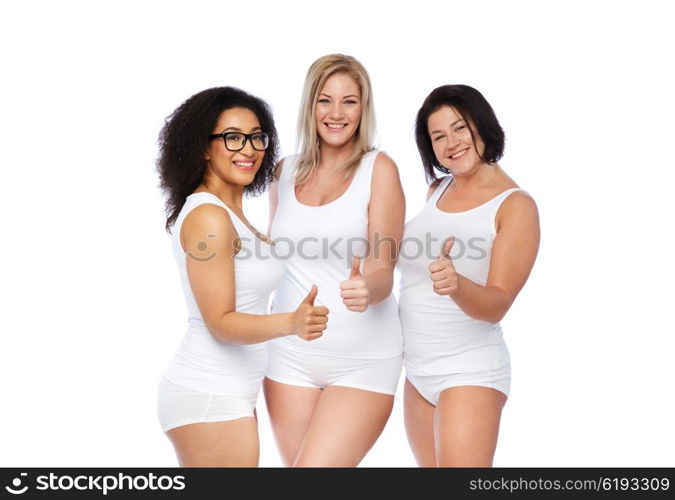 gesture, friendship, beauty, body positive and people concept - group of happy plus size women in white underwear showing thumbs up