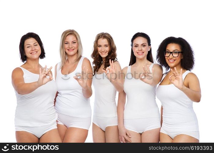 gesture, friendship, beauty, body positive and people concept - group of happy different women in white underwear showing ok hand sign