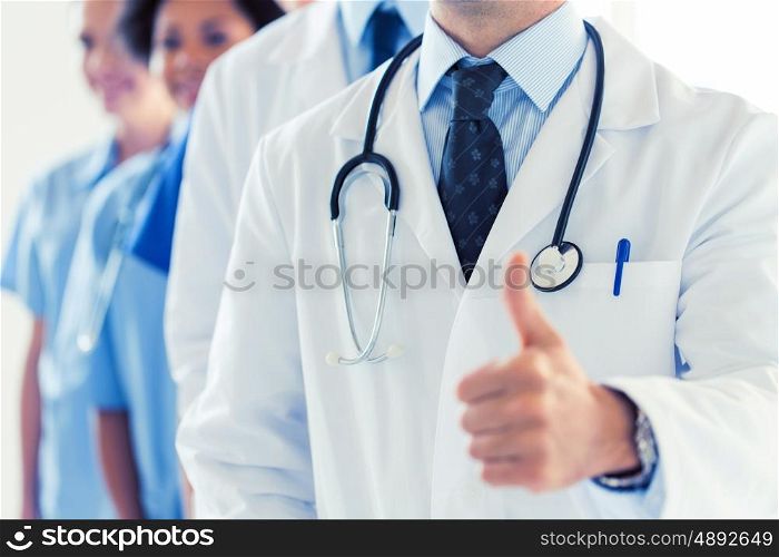 gesture, health care, people and medicine concept - close up of happy doctor showing thumbs up