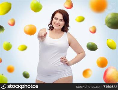 gesture, healthy eating, diet, weight loss and people concept - smiling young plus size woman in underwear pointing on you over fruits background