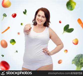 gesture, healthy eating, diet, weight loss and people concept - smiling young plus size woman in underwear pointing on you over food background