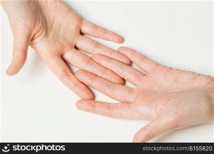 gesture, people and body parts concept - close up of two hands connecting fingers together