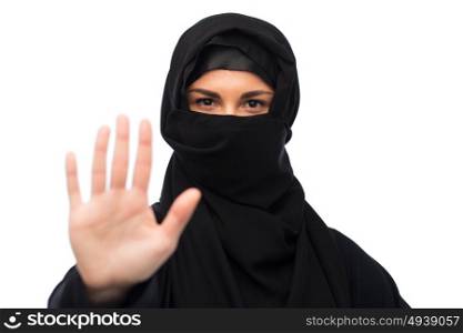 gesture, religious prohibition and people concept - muslim woman in hijab showing stop sign over white background. muslim woman in hijab showing stop sign