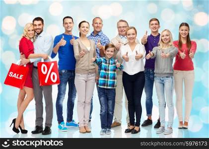 gesture, sale, discount, generation and people concept - group of happy people showing thumbs up and couple with shopping bags