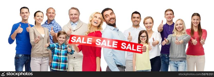 gesture, sale, shopping and people concept - group of smiling men, women and kids showing thumbs up and holding red sale sign or banner