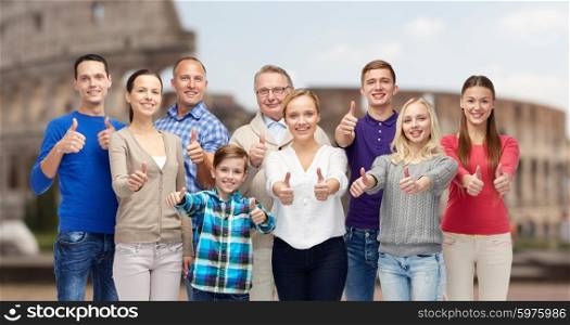 gesture, travel, tourism and people concept - happy family showing thumbs up over coliseum background