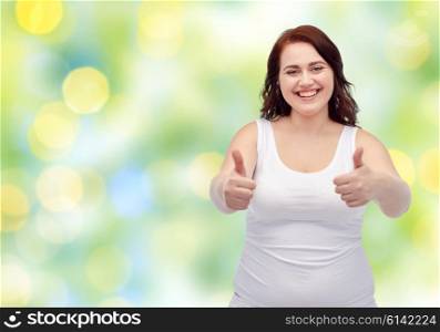 gesture, weight loss and people concept - smiling young plus size woman in underwear showing thumbs up over green lights background