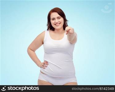 gesture, weight loss and people concept - smiling young plus size woman in underwear showing over blue background