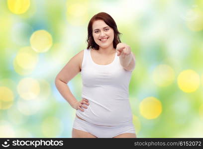 gesture, weight loss and people concept - smiling young plus size woman in underwear showing over green lights background