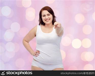 gesture, weight loss and people concept - smiling young plus size woman in underwear showing over pink holidays lights background