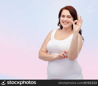 gesture, weight loss and people concept - smiling young plus size woman in underwear showing ok hand sign over rose quartz and serenity gradient background