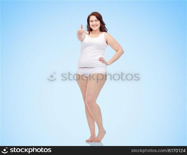 gesture, weight loss and people concept - smiling young plus size woman in underwear showing thumbs up over blue background