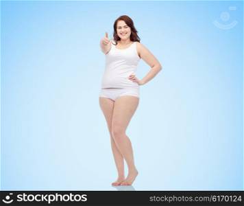 gesture, weight loss and people concept - smiling young plus size woman in underwear showing thumbs up over blue background