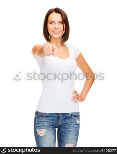 gestures and people concept - happy woman in blank white t-shirt pointing at you