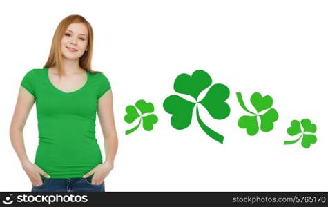 gestures, holidays, st. patricks day and people concept - happy teenager in blank green t-shirt over white background with shamrock or clover