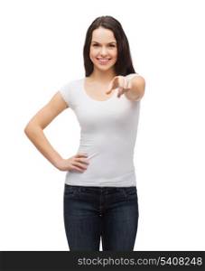 gestures, t-shirt designes and people concept - happy teenager in blank white t-shirt pointing at you
