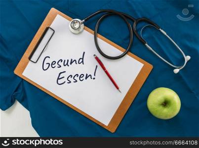 Gesund Essen (in german Healthy eating) clipboard with stethoscope.. Gesund Essen (in german Healthy eating) clipboard with stethoscope