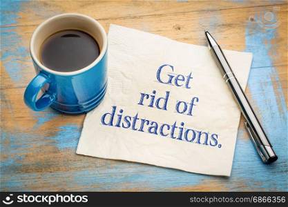Get rid of distractions advice or reminder - handwriting on a napkin with a cup of espresso coffee