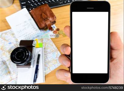 getting ready with smart phone for travel, money, map and photo camera on wooden table with copy space