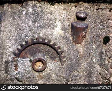Gewicht und Zahnrad. old etalon and gear in concrete