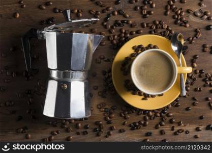 geyser coffee maker near yellow cup with spoon plate