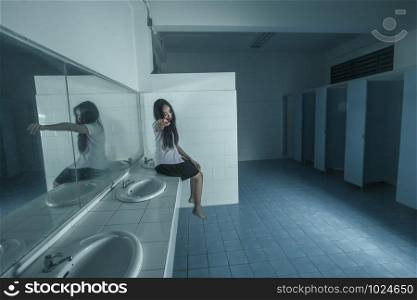 Ghost university girl sitting in restroom,Dark tone