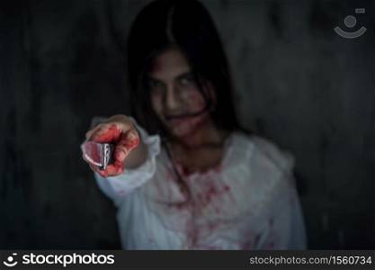 Ghost woman or Zombie holding point knife in dark room house ,halloween concept