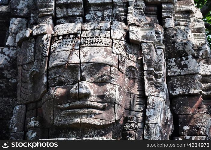 Giant ancient buddha rock statue at Angkor Cambodia