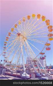 Giant ferris wheel in Amusement park with blue sky background pastel color tone
