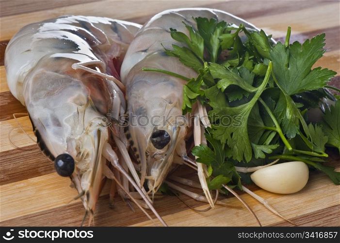 Giant shrimp on a wooden cutting board bamboo