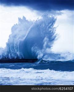 Giant wave splash, big powerful tide in action, storm weather in a deep blue ocean, forces of nature, natural disaster