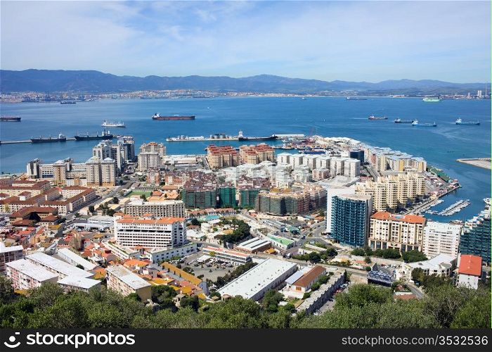 Gibraltar town urban scenery and Gibraltar Bay on southern part of Iberian Peninsula, Spain on the horizon.