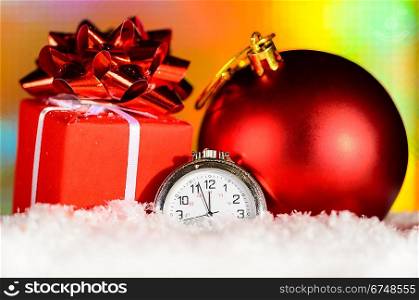 gift box and clock on snow