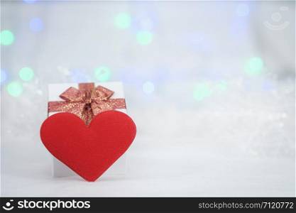 gift box and mini heart pillow on the white fur, bokeh background, with copy space for season greeting, Happy New Year, AF point selection, blurred.