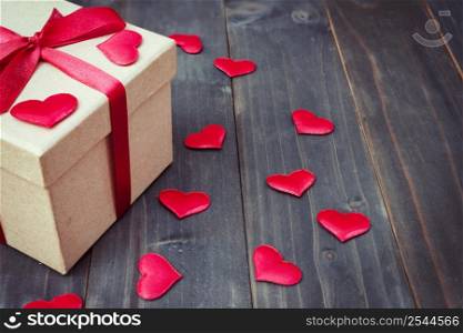 gift box and red heart on wooden table background with copy space.