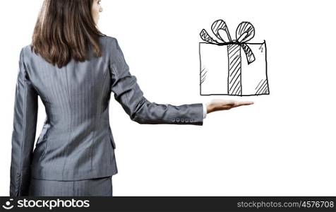Gift box. Back view of businesswoman holding present box in hand