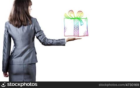 Gift box. Back view of businesswoman holding present box in hand