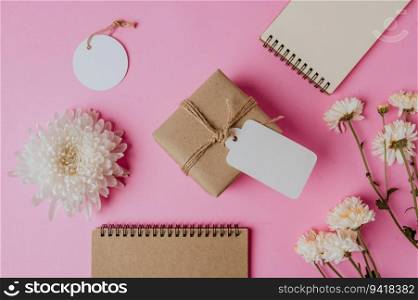 gift box, flower and a book on pink background