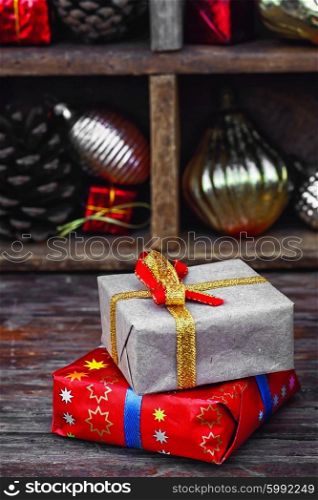 Gift box for Christmas. Cardboard box with gift on background of box with Christmas decorations.